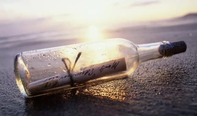 Rolled message in a bottle surprise Message rolled inside a glass bottle