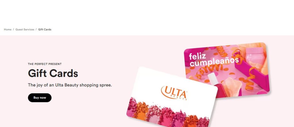 User opening the official Ulta Beauty mobile app on a smartphone and browsing the Ulta website homepage on a laptop