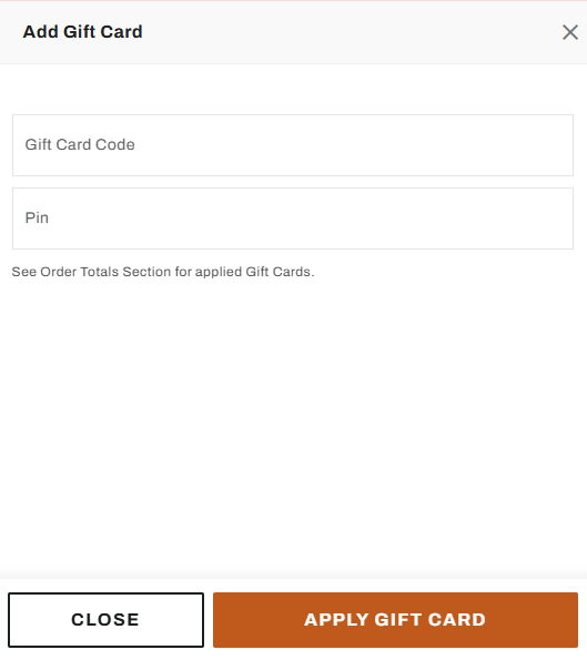 Image showing a cashier manually entering the Dick’s gift card number into the store’s checkout register system during in-person redemption.

