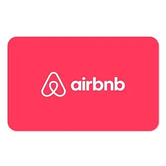An Airbnb gift card placed on a wooden table with a miniature home model, travel journal, and coffee cup, representing cozy and flexible global stays. An Airbnb gift card placed on a wooden table with a miniature home model, travel journal, and coffee cup, representing cozy and flexible global stays.